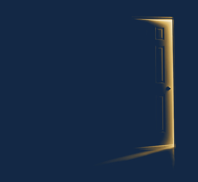 A door standing open in a dark room, with warm light coming through